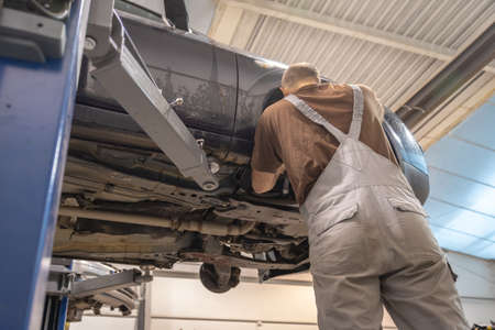 Replacing winter tires on summer tires in a professional garage with the help of professional tools. Modern service.の写真素材