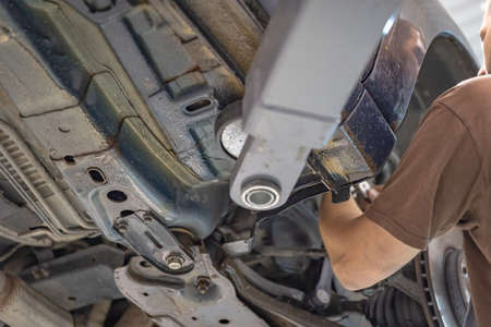 Repair and check car in repair shop. An experienced technician repairs the faulty part of the car. I...