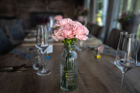 Flower decoration at the wedding. Wedding bouquet of bride and witness. Golden wedding rings on the flowersの写真素材