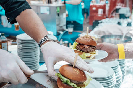 Catering for birthday party, wedding, event. Grilling meat, corn, burger, sausage, sunflower, vegetables. Fruit Dishes, Dessert, Salads, Pasta, Sweetsの写真素材