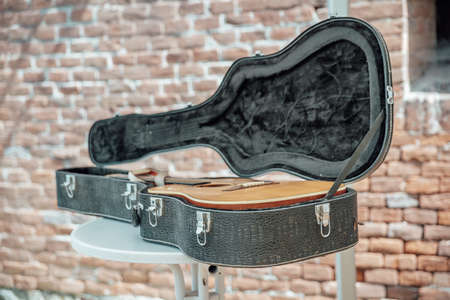 the musical instruments ready for the concert lie on a stage in a caseの写真素材