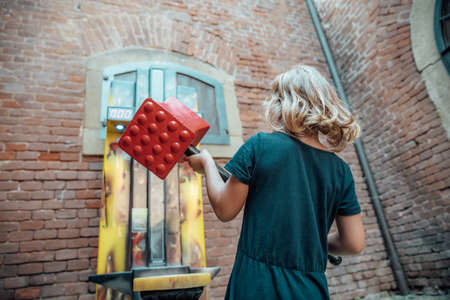 girl playing a game with a big hammer.の写真素材