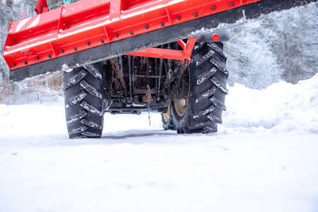 big tractor cleans road from snow in the winter. seasonal workの写真素材