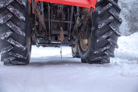 big tractor cleans road from snow in the winter. seasonal work
