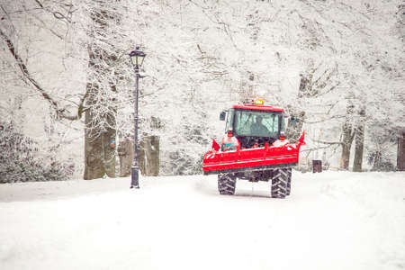 big tractor cleans road from snow in the winter. seasonal workの写真素材
