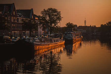 Sunrise over a canal at a windmill in the Netherlands Amsterdam in summerの写真素材