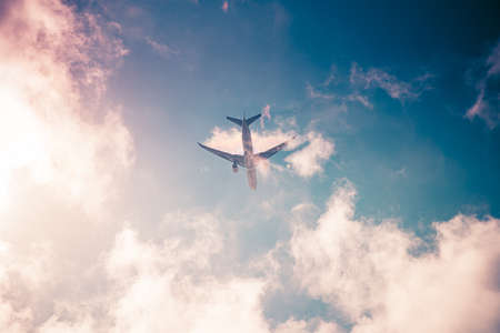 Airplane on blue sky. Travel around the world in the airの写真素材