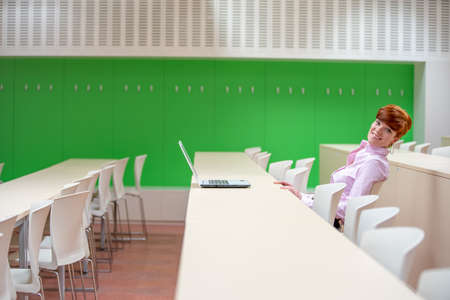 Young beautiful woman on a university lecture working on a laptopの写真素材