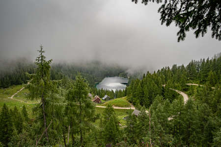 hikers in the austrian alps walk on mountain hiking trails in the woods around the lakes