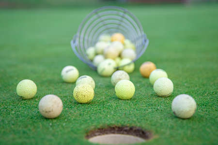 golf equipment on green golf course, balls and sticks ready to play.の写真素材