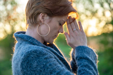 young woman meditates and pray at sunrice