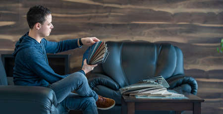 the man chooses the color of the new carpet according to the pattern book in the flooring shop