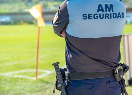 security guard on a football match. title on his back in Spanish bodyguardsの写真素材