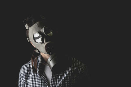 Man in the old military gas mask, escaping the reality of the duties of managerial life.の写真素材