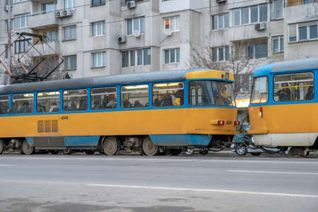 Sofia - February 27, 2020: prefabricated house in the city on settlements. tram at the stop in front...