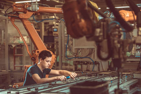 setup and service of the production line with robotic arms in the factory