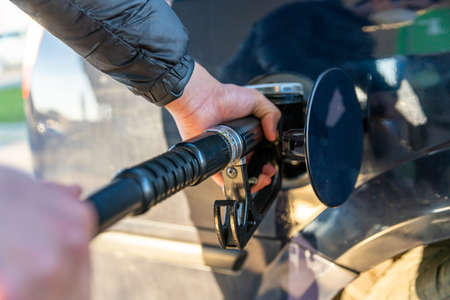 refueling a passenger car tank at a gas station.の写真素材
