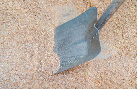 Shovel in sawdust in a carpentry workshopの写真素材