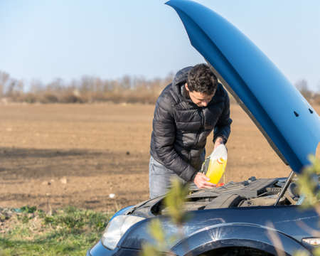 The man refills the windscreen washer fluidの写真素材