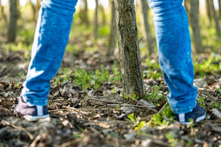 man peeing on a tree in the woods