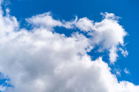 white clouds in the blue sky in sunny weather