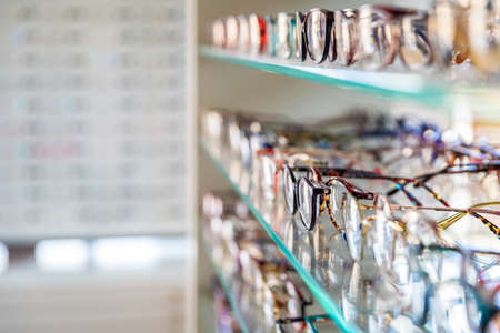 glasses on a display case shelf in an optics store. copy spaceの写真素材