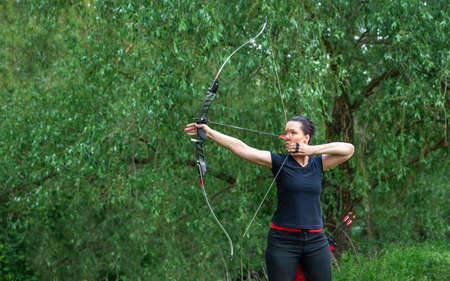 arrow shooting from a bow in nature, sport archery. copy space