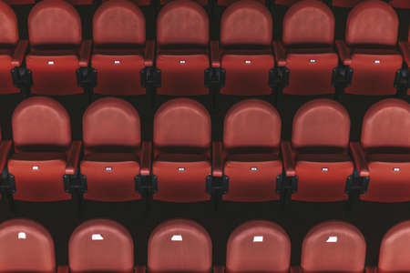 empty red chairs in the outdoor arena