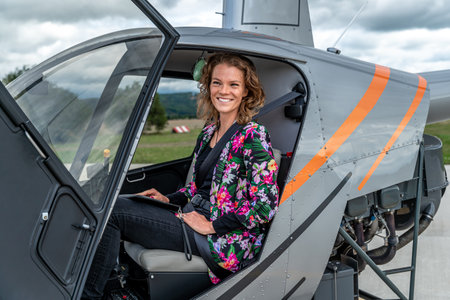 transport by helicopter. A young woman in a helicopter travels to a buseness meetingの写真素材