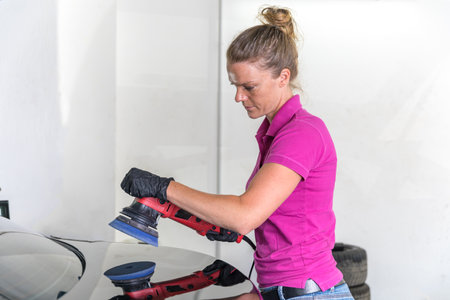 woman polishing car body in service