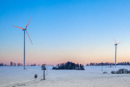 wind power plants in the field at sunriseの写真素材