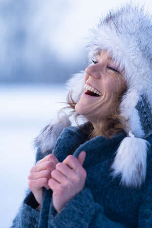 beautiful woman in winter clothes with a smile on her faceの写真素材