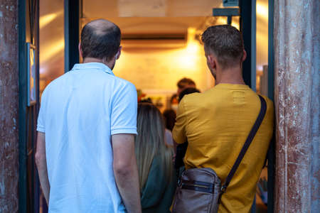 queue at the door to the storeの写真素材