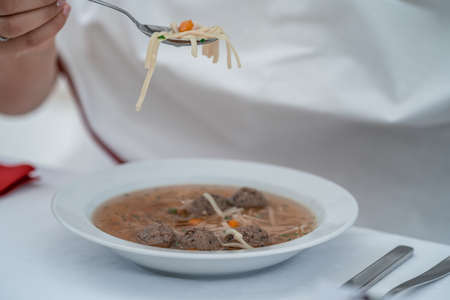 beef broth with liver dumplings at a festive lunchの写真素材