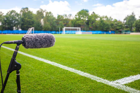 directional microphone on a football field to record sound when broadcasting for TVの写真素材