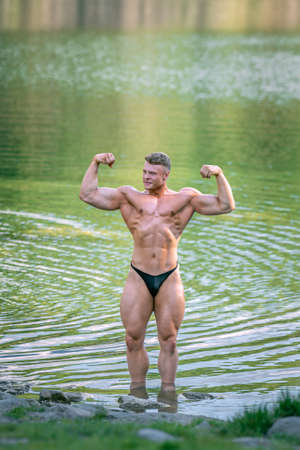 male bodybuilder in the water in natureの写真素材