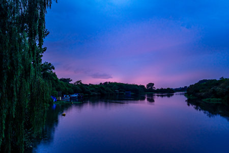 sunset on the river in the villageの写真素材