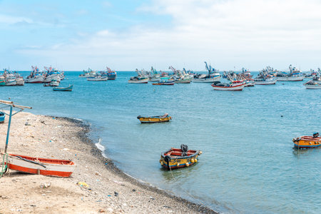 Peru - September 21, 2022: fishing boats in the ocean at the shore of the villageのeditorial素材