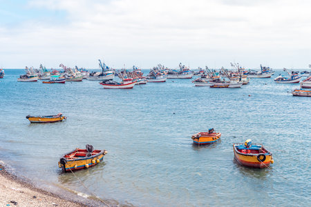 Peru - September 21, 2022: fishing boats in the ocean at the shore of the villageのeditorial素材
