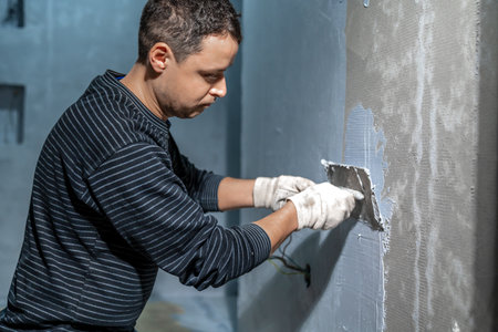 manual application of waterproofing to the wall on the construction siteの写真素材