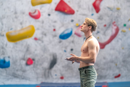 young man on a boulder climbing wall