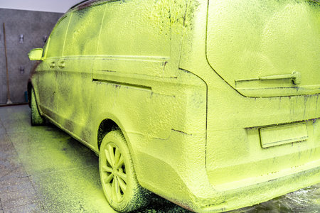 wash cars with green active foam in the garageの写真素材