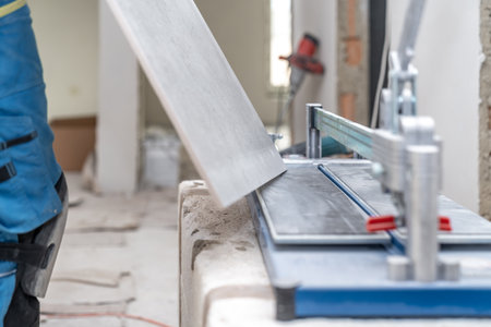 manual cutting of facing tiles on a cutterの写真素材