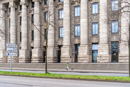 Cologne, Germany - March 23, 2023: historic administrative building with a modern electric scooter in front of the entranceのeditorial素材