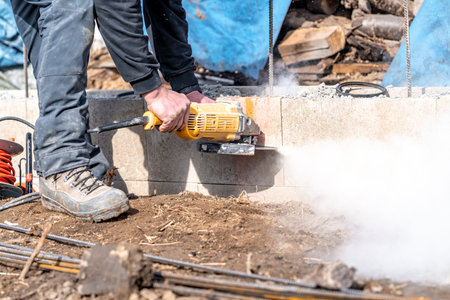 cutting concrete bricks with an electric grinder