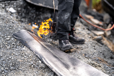 heating the asphalt with a flame. waterproofing of the foundation and walls of the house