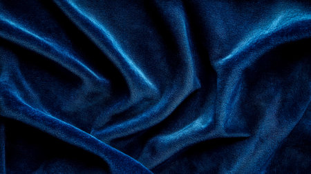 Luxurious deep blue velvet fabric draped elegantly, creating soft, rich textureの素材