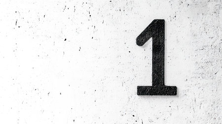 Number one sign on white textured wall conveys minimalismの素材