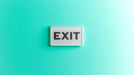 Exit sign on teal green background conveying emergency escape routeの素材