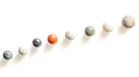 Colorful marbles rolling down on white backgroundの素材